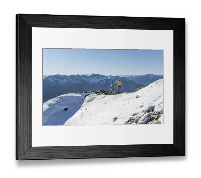 Framed Print : Mountaineer looks over snow-covered mountains Framed Print : Mountaineer looks over snow-covered mountains