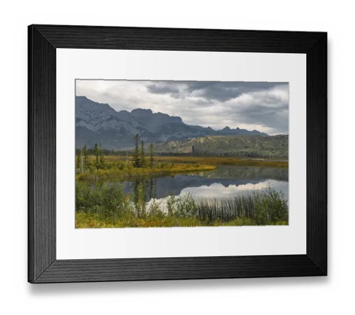 Framed Print : Hilly landscape reflected in a lake