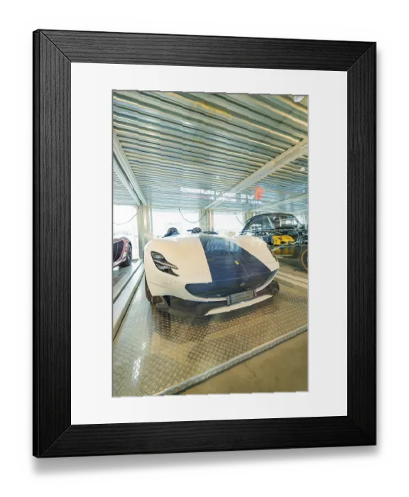 Framed Print : White sports car and classic car in a brightly lit exhibition hall Framed Print : White sports car and classic car in a brightly lit exhibition hall