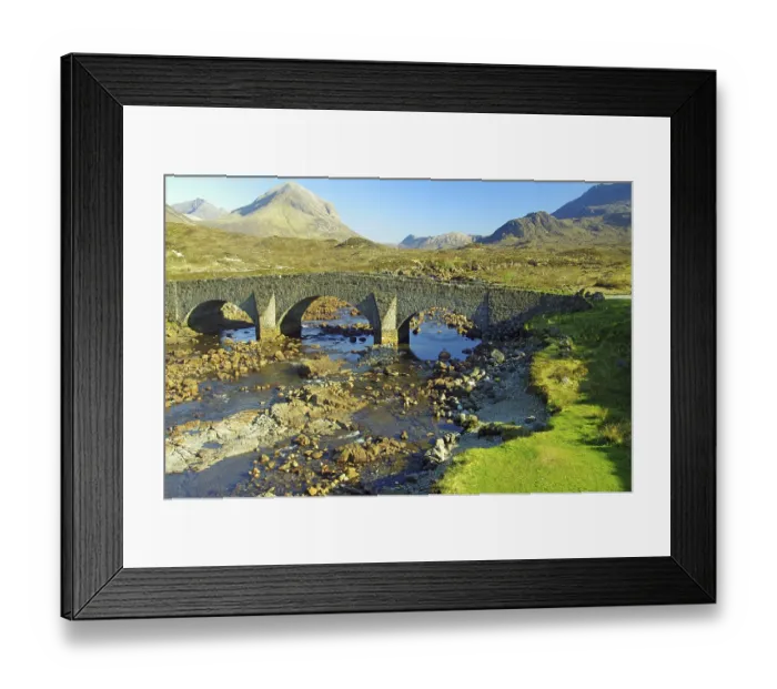 Framed Print : Historic stone bridge over a shallow river with mountains in the background Framed Print : Historic stone bridge over a shallow river with mountains in the background
