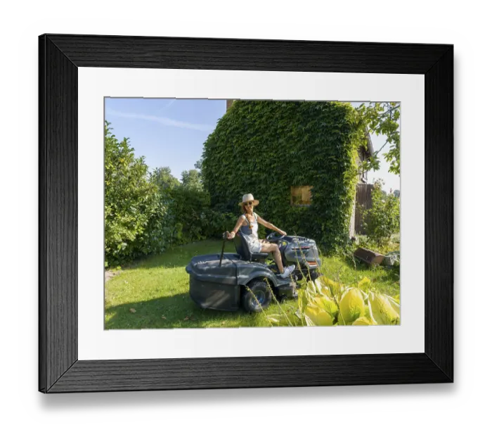 Framed Print : Woman driving lawn mower, lawn tractor