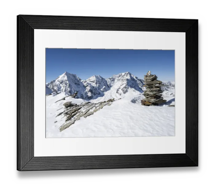 Framed Print : Cairns in the snow, mountain panorama with snow-covered mountain landscape in winter