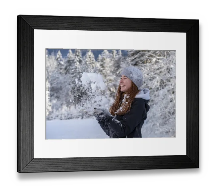 Framed Print : Woman enjoying the snow during winter walk