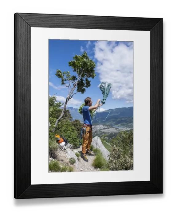 Framed Print : Climber throws climbing rope over his shoulder