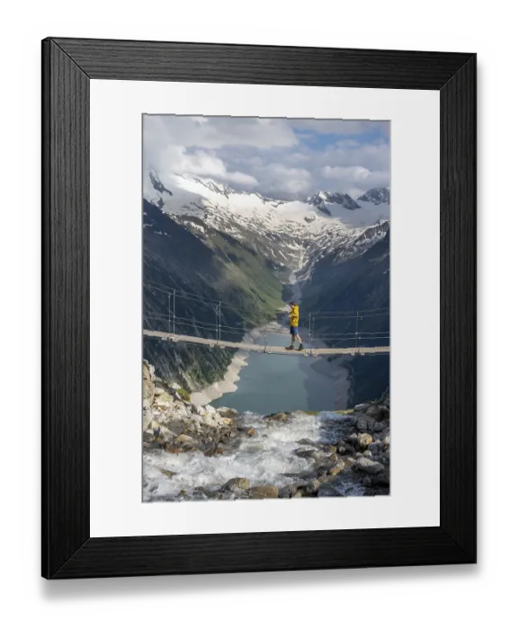 Framed Print : Mountaineers on a suspension bridge over a mountain stream Alelebach
