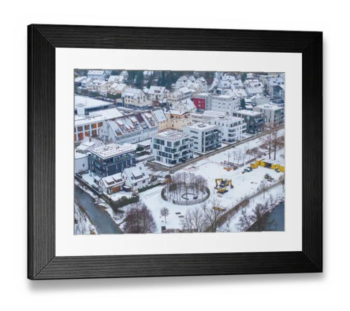 Framed Print : Construction site next to modern residential buildings in a snowy cityscape