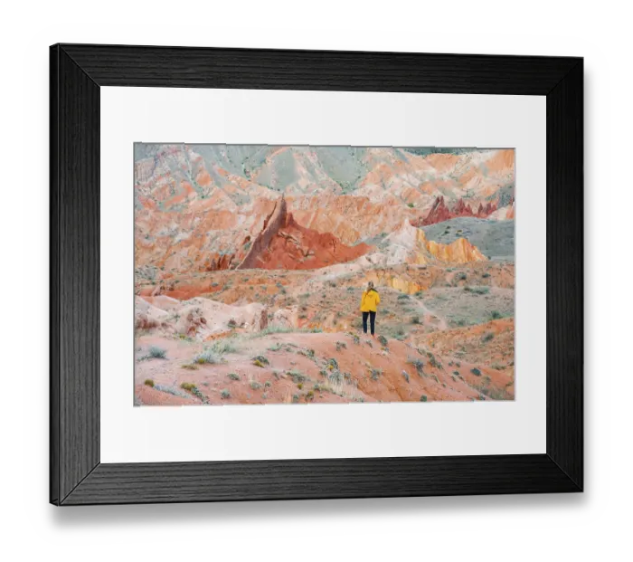 Framed Print : Hiker in front of eroded mountain landscape