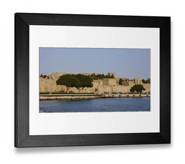 Framed Print : The fortress walls on the coast form a peaceful retreat next to the clear water