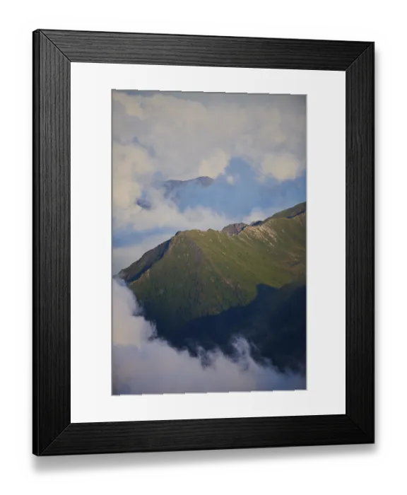Framed Print : Evening light on the mountauns and clouds hanging in the mountains