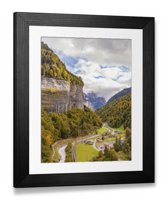 Framed Print : View of the valley with winding river and small settlement under wooded mountains