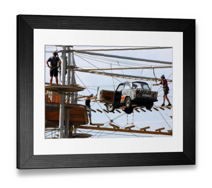 Framed Print : Berlin, 31.07.2010, Climbers balance over a Trabant suspended on ropes in the high ropes course Mount Mitte Framed Print : Berlin, 31.07.2010, Climbers balance over a Trabant suspended on ropes in the high ropes course Mount Mitte