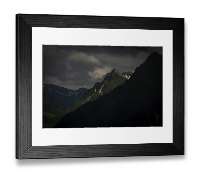 Framed Print : Grassy summit with remnants of snow and dramatic clouds Framed Print : Grassy summit with remnants of snow and dramatic clouds