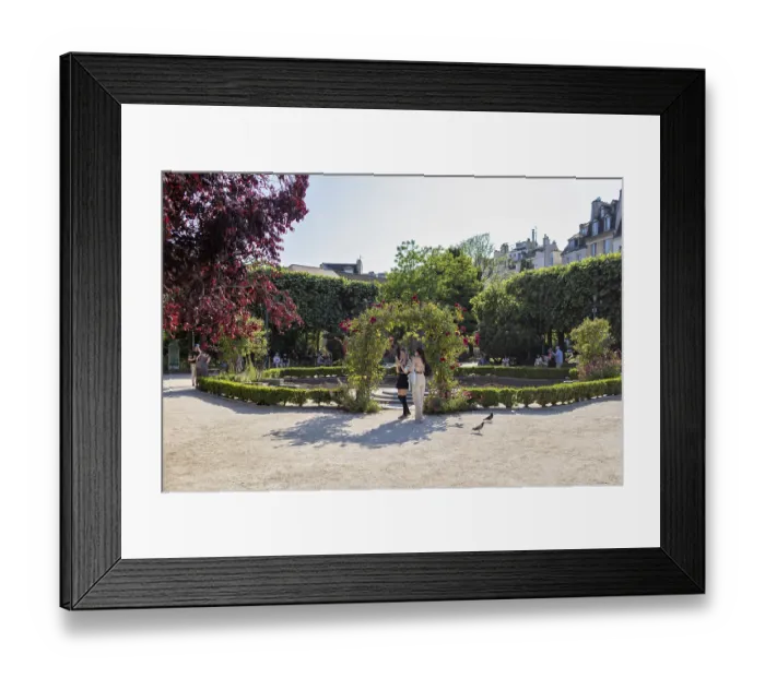 Framed Print : A sunny garden in the city with trees and people out for a walk