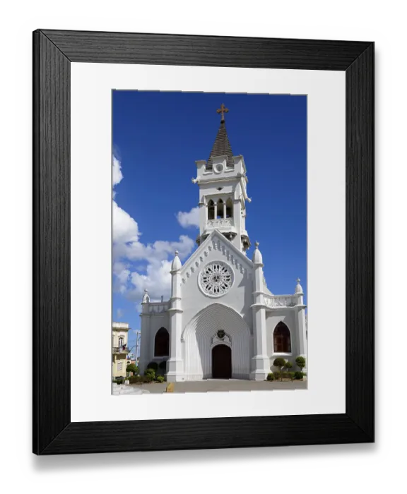 Framed Print : White church with bell tower and Gothic architecture under a clear blue sky