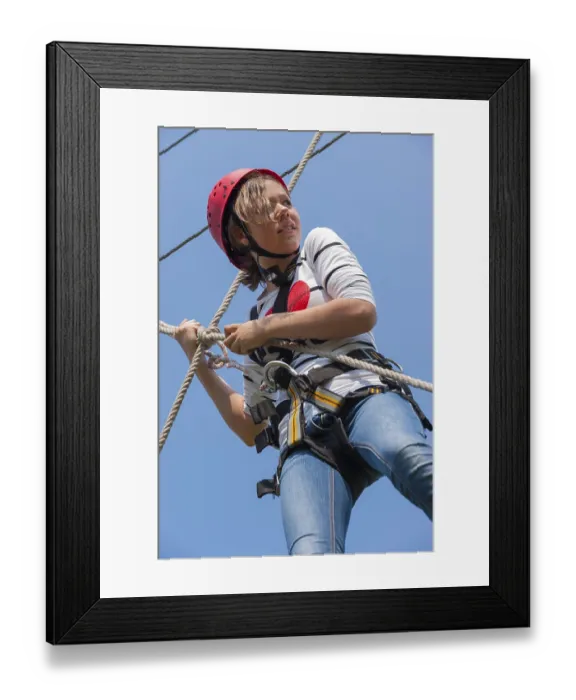 Framed Print : Young girl in climbing park, climbing