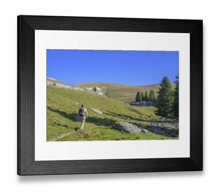 Framed Print : Hiker walking towards rock formations of surface karst Framed Print : Hiker walking towards rock formations of surface karst