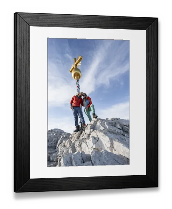 Framed Print : Couple, two mountaineers in front of a golden summit cross