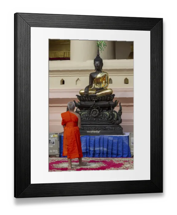 Framed Print : Monk in front of a Buddha statue