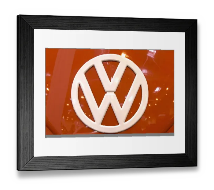 Framed Print : The front of a Volkswagen bus with a large VW logo