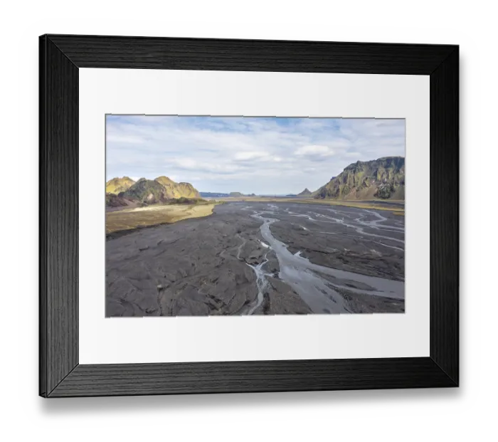 Framed Print : River with fanned out branches through black lava sand