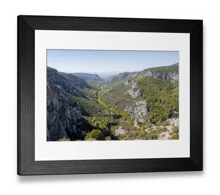 Framed Print : View into a valley with rock walls in the mountains
