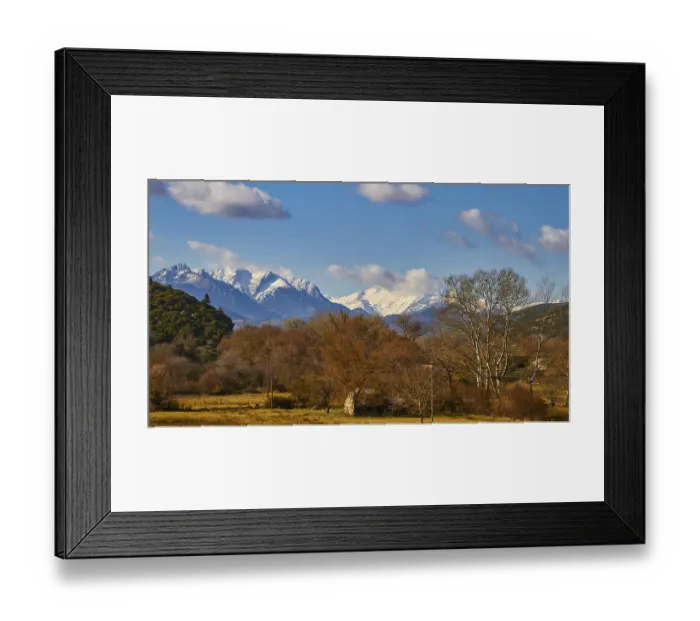 Framed Print : Rural scene with snow-covered mountains and trees in the foreground Framed Print : Rural scene with snow-covered mountains and trees in the foreground