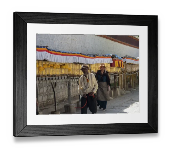 Framed Print : Pilgrims at golden prayer wheels