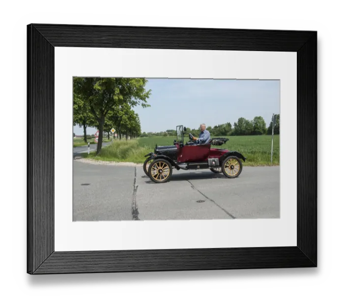 Framed Print : Man driving a classic Ford vintage car on an open country road