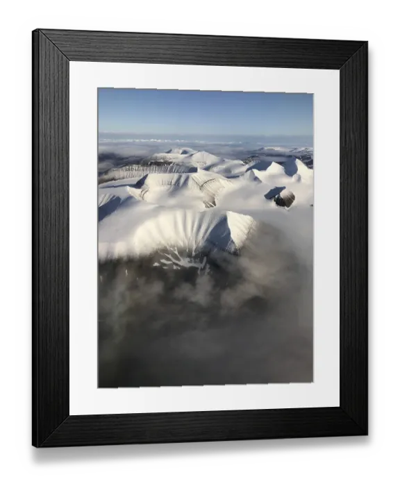 Framed Print : Aerial view, mountain peak with snow above cloud cover Framed Print : Aerial view, mountain peak with snow above cloud cover