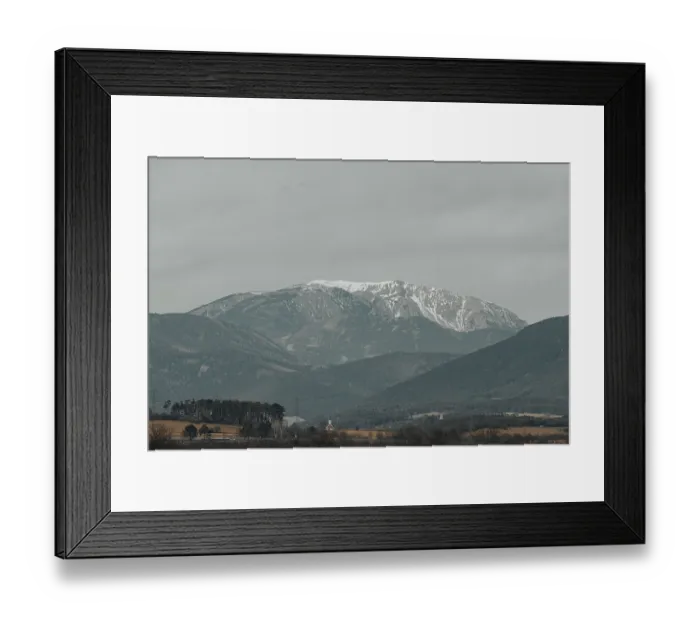 Framed Print : Snow-covered mountain landscape with cloudy sky Framed Print : Snow-covered mountain landscape with cloudy sky