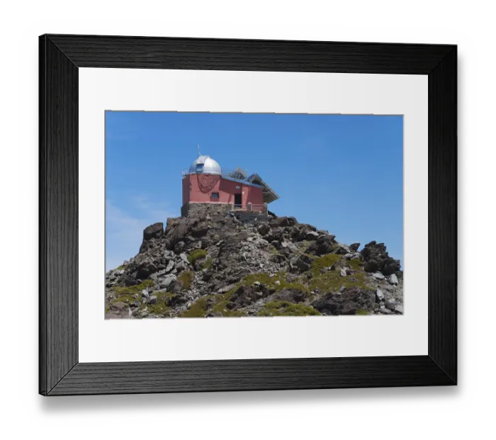 Framed Print : Close-up of a red observatory on a rocky hill under a blue sky