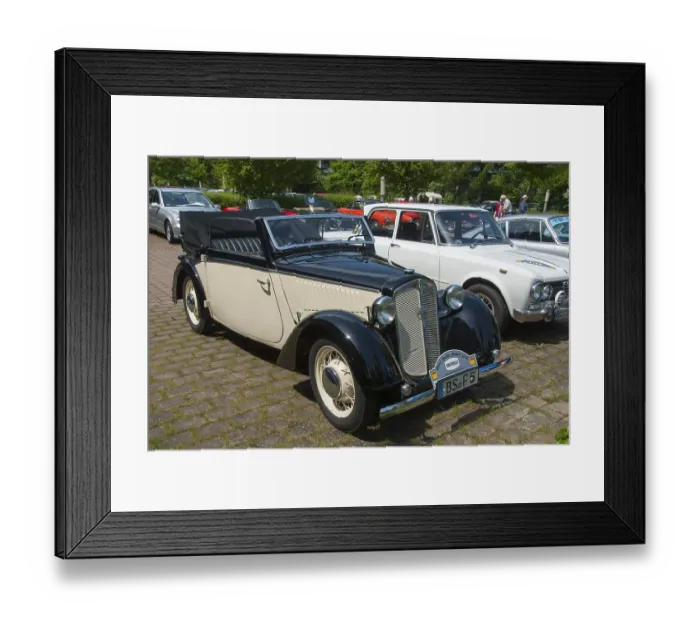 Framed Print : Classic black and white vintage car in an open-air car park with other vintage cars in the background Framed Print : Classic black and white vintage car in an open-air car park with other vintage cars in the background