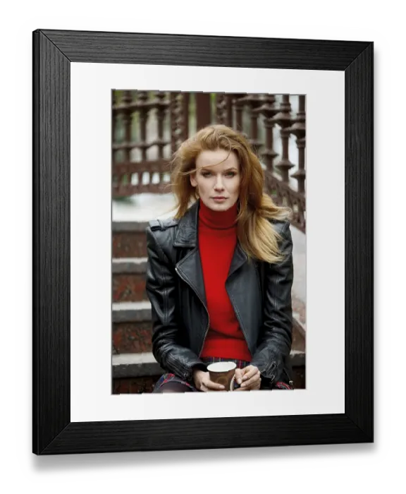 Framed Print : Portrait of red hair lady in leather jacket with cardboard cup in hand sitting on stairs
