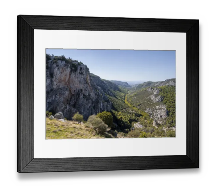 Framed Print : View into a valley with rock walls in the mountains