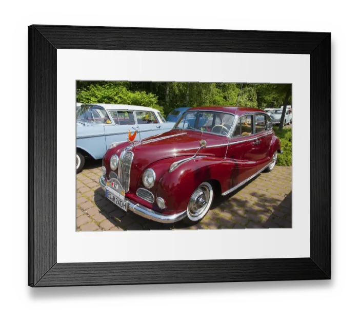 Framed Print : Red vintage car from the 50s in a car park in front of a forest Framed Print : Red vintage car from the 50s in a car park in front of a forest