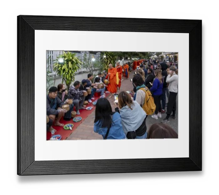 Framed Print : Tourists take pictures of monks during the Morning Alms ceremony