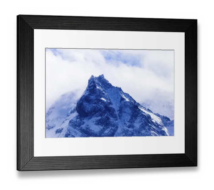 Framed Print : Fog envelops the snowy summit of the mountain Le Besso
