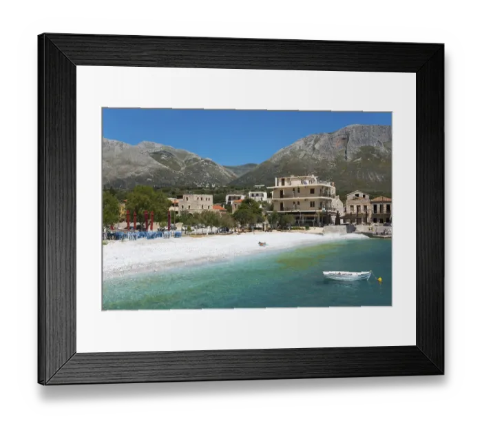 Framed Print : View of a quiet coastal village with mountains in the background and clear blue sea Framed Print : View of a quiet coastal village with mountains in the background and clear blue sea