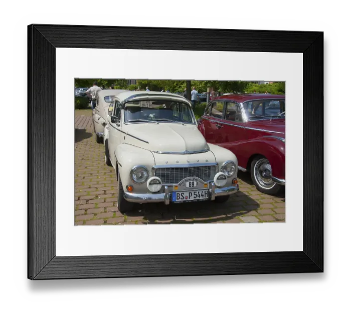 Framed Print : A white Volvo classic car stands in the sun