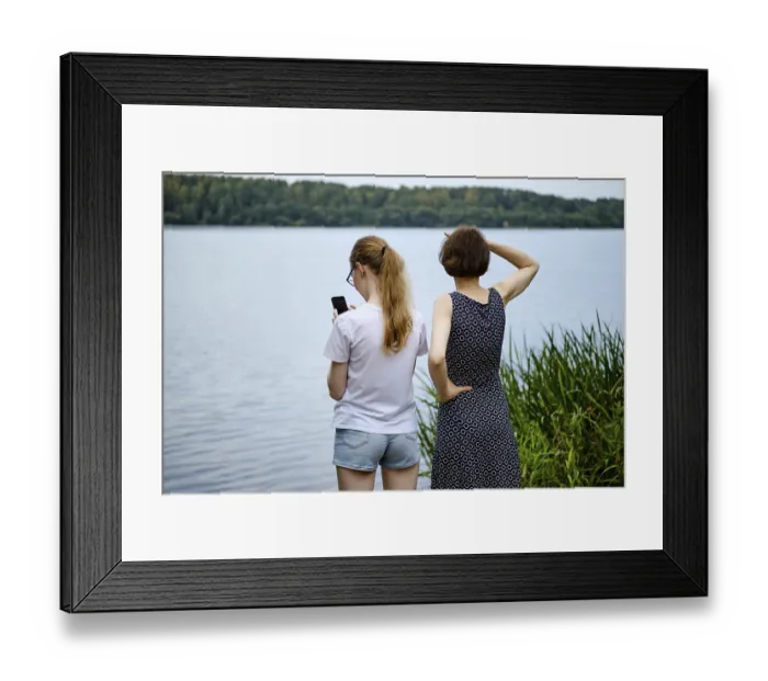 Framed Print : Mother and daughter have come to the shore of the lake and are exploring the surroundings Framed Print : Mother and daughter have come to the shore of the lake and are exploring the surroundings