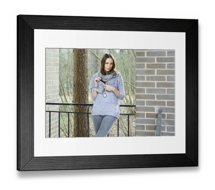 Framed Print : Attractive lady in sweater and scarf standing on balcony of the house in forest