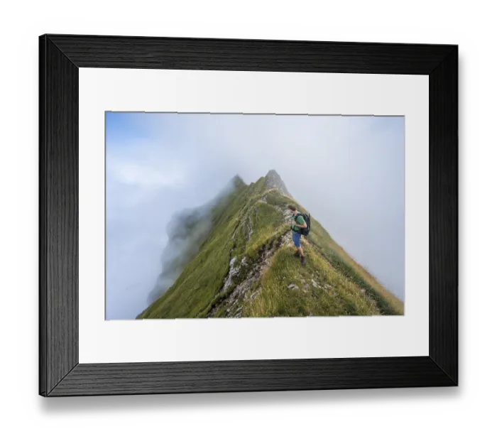 Framed Print : Climbers on a narrow ridge, steep grassy mountains in the fog