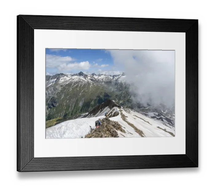 Framed Print : Mountaineer on a rocky ridge with snow