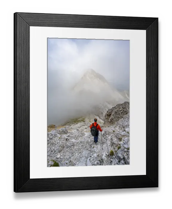 Framed Print : Mountaineer descending on a rocky mountain path