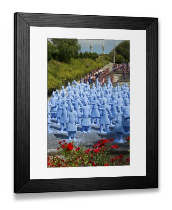 Framed Print : A large number of blue terracotta soldier statues stand on a path lined with flowers Framed Print : A large number of blue terracotta soldier statues stand on a path lined with flowers