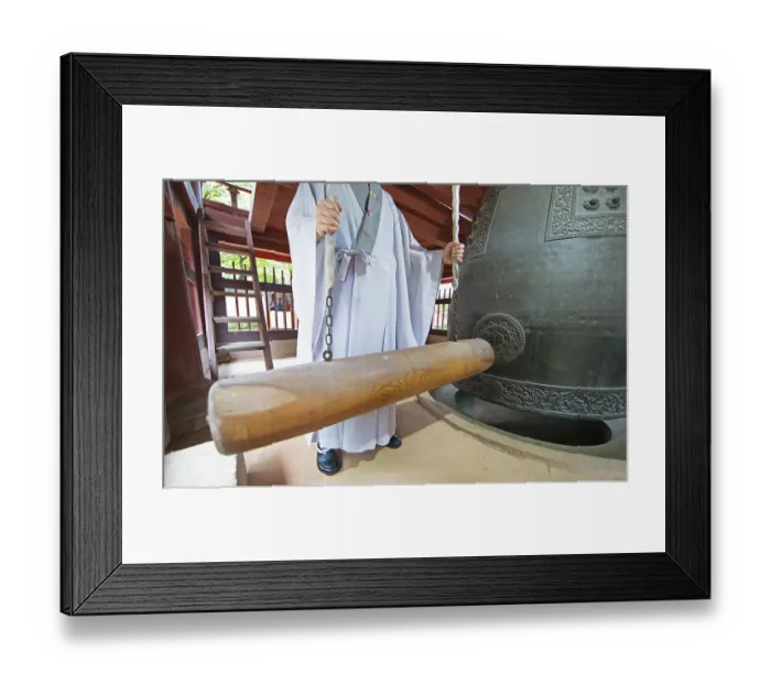 Framed Print : Korean monk strikes the bell with a wooden trunk Framed Print : Korean monk strikes the bell with a wooden trunk