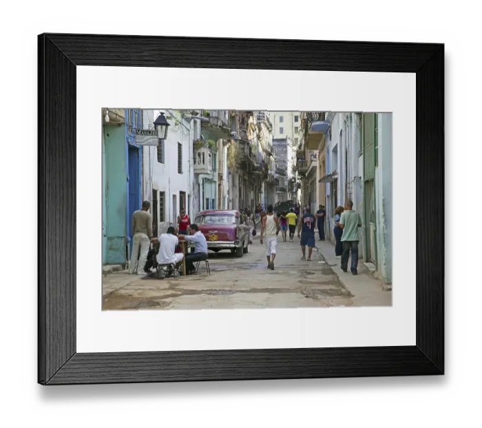 Framed Print : Busy street scene and red old 1950s vintage American car