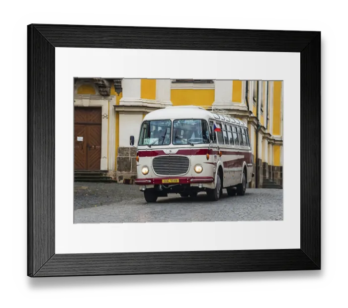 Framed Print : A traditional bus in front of a magnificent yellow historical building in an urban environment