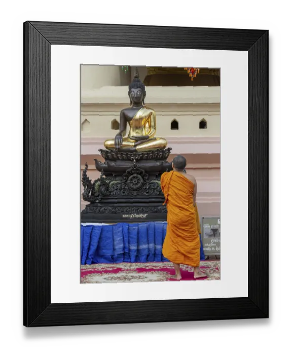 Framed Print : Monk in front of a Buddha statue Framed Print : Monk in front of a Buddha statue