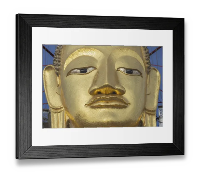 Framed Print : Face of a 32 metre high standing Buddha decorated with glass mosaics and 24-carat gold Framed Print : Face of a 32 metre high standing Buddha decorated with glass mosaics and 24-carat gold
